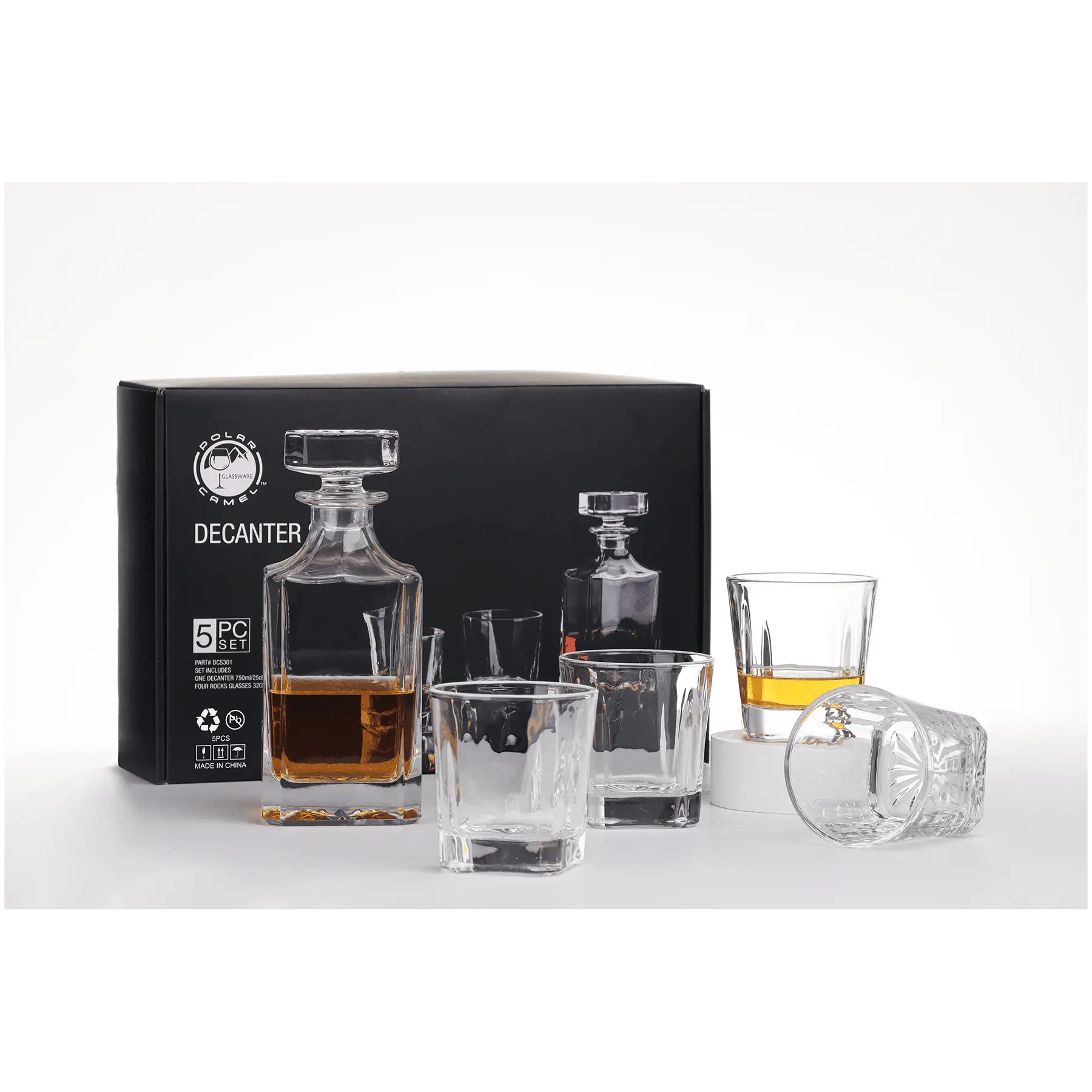 Personalized 750mL whiskey decanter set with four 11 oz Rock glasses, displayed in front of sleek black packaging. — ideal for gifting or personal use.