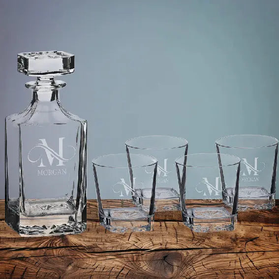 Personalized square 850ml whiskey decanter set with four matching 11 oz rocks glasses displayed on a rustic wooden surface.